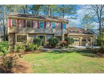 Charming two-story home featuring a well-manicured lawn and attached two car garage at 2585 Arrow Wood Ne Dr, Marietta, GA 30068