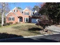 Charming brick two-story home with landscaped front yard and attached two car garage at 2335 Corbett Ct, Powder Springs, GA 30127