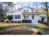 Charming yellow two-story home with green shutters and inviting front porch at 7364 N Mitchell N Ct, Villa Rica, GA 30180