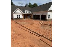 New construction home with white siding, brick accents, and an attached two car garage at 215 Pinewood Dr, Covington, GA 30014