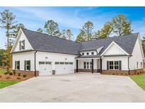 Stunning home featuring a white exterior, black shutters, and a spacious three-car garage at 215 Pinewood Dr, Covington, GA 30014