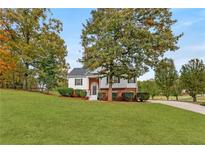 Charming two-story home with well-manicured lawn and mature trees at 5077 Fieldview Dr, Douglasville, GA 30135