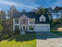 Beautiful two-story home with a well-manicured lawn and a two-car garage in a quiet, wooded neighborhood at 77 Hunters Grn, Dallas, GA 30157