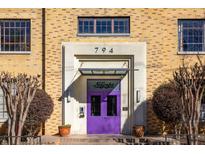 A charming brick building entrance featuring a purple door, decorative plants, and an awning at 794 Ralph Mcgill Ne Blvd # 8, Atlanta, GA 30312