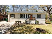 Charming single-story home with neutral siding, dark shutters, and a cozy front porch at 2215 Gordon Se Cir, Smyrna, GA 30080