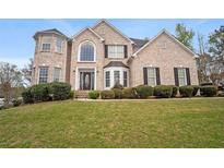 Charming brick home featuring well-manicured landscaping and a welcoming front entrance at 1536 Granby Ln, Locust Grove, GA 30248