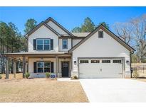 Charming two-story home featuring a covered porch and a two-car garage at 2320 Ridge View Dr, Loganville, GA 30052