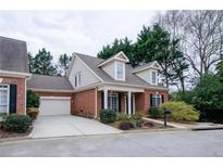 Charming brick home featuring a two-car garage, well-manicured lawn, and dormer windows at 2861 Lavista Rd, Decatur, GA 30033