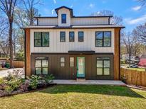 Modern two-story home with light siding and a teal front door, set on a manicured lawn at 3087 Alston Dr, Decatur, GA 30032