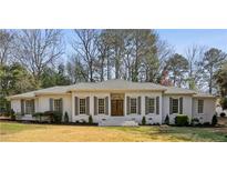 Charming ranch style home with grey shutters and a well manicured front lawn at 446 Cove Ne Dr, Marietta, GA 30067