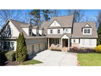 Charming two-story home with a three-car garage and a well-maintained front yard at 230 Hardscrabble Rd, Roswell, GA 30075