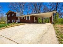 Charming brick home with a covered carport and ample parking space at 2742 Bomar Rd, Douglasville, GA 30135