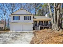 Charming two-story home featuring a covered front porch and a two-car garage at 155 Hitchcock Dr, Villa Rica, GA 30180