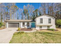 Lovely home with a gray garage door and an inviting bright blue front door at 2330 Regal Ct, Lawrenceville, GA 30044