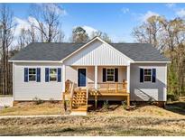Charming single story home with gray siding, blue shutters and wood porch at 122 S Mill Creek Ct, Woodstock, GA 30188