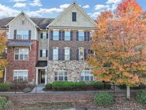 Charming brick and stone townhome with a well-manicured lawn and lovely landscaping at 1222 Poston Se Pl, Smyrna, GA 30080