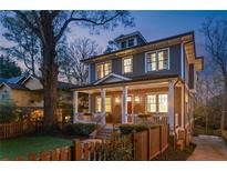 Charming two-story home featuring a welcoming front porch with white columns and a manicured front yard at 213 Oak Ln, Decatur, GA 30030