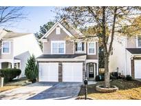 Charming two-story home featuring a two-car garage, front yard and covered porch at 946 Gardenia Curv, Canton, GA 30114