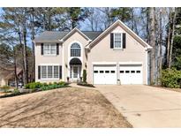 Charming two-story home featuring a well-manicured front yard and a two-car garage at 2002 Stonewick Ct, Lawrenceville, GA 30043