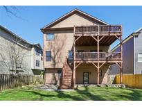 The exterior features a spacious wooden deck and a well-maintained lawn at 2108 Main Nw St, Atlanta, GA 30318