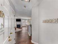 Welcoming entryway with hardwood floors leads into a cozy living area featuring a fireplace and abundant natural light at 244 13Th Ne St # 302, Atlanta, GA 30309