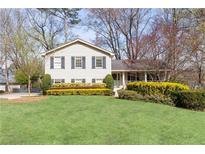 Charming two-story home featuring a well-manicured lawn and neatly trimmed hedges at 3605 Wood Valley Ne Ct, Brookhaven, GA 30319