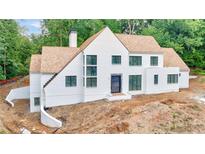 Stunning white brick home boasts wood shingle roof, modern windows, and sophisticated architectural design at 2983 Habersham Nw Ct, Atlanta, GA 30305