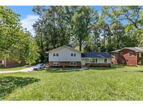 Charming two-story home with gray siding, brick accents, and a lush front lawn at 4373 Sun Valley Blvd, Atlanta, GA 30344