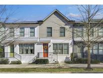 Charming townhome featuring a bright orange front door and a well-maintained, landscaped yard at 1181 Rambler Cross, Atlanta, GA 30312