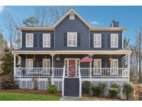 Charming two-story home with a welcoming front porch and well-maintained landscaping at 1609 Twin Courts Sw Ln, Marietta, GA 30008