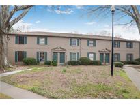 Charming brick townhouse with green shutters, landscaping, and welcoming front doors at 3077 Colonial Way # F, Atlanta, GA 30341
