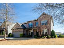 Beautiful two story home with brick exterior and well-maintained landscaping at 3815 Pleasant Woods Dr, Cumming, GA 30028