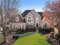 Stunning exterior elevation showcasing the home's architecture and beautifully landscaped front yard at 700 Clubside Dr, Roswell, GA 30076