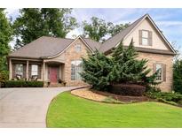 Charming stone-and-shingle home with landscaped front yard and inviting curved driveway at 1976 Hedge Brooke Nw Trl, Acworth, GA 30101