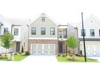 Charming two-story home with a brick and siding exterior and an attached two-car garage at 1067 Crest Mill Dr, Marietta, GA 30008