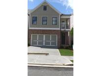 Charming two-story home featuring a brick facade and attached two-car garage at 1067 Crest Mill Dr, Marietta, GA 30008