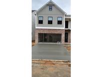 New construction home with board and batten siding, brick accents, and a concrete driveway leading to a two-car garage at 1067 Crest Mill Dr, Marietta, GA 30008