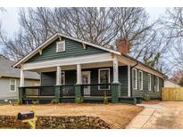 Charming craftsman home with a welcoming front porch, complemented by fresh landscaping and a well-maintained lawn at 973 Parsons Sw St, Atlanta, GA 30314