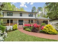 Charming two-story home featuring a brick pathway and colorful landscaping leading to a welcoming front porch at 2672 Langland Ne Ct, Atlanta, GA 30345
