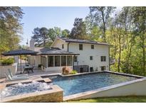 Backyard features a pool, hot tub and outdoor seating at 2672 Langland Ne Ct, Atlanta, GA 30345