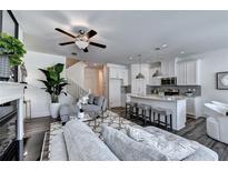 Open concept living room featuring an island kitchen, modern furniture, and plenty of natural light at 2698 Ne Almand Ln, Conyers, GA 30013