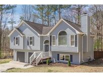 Charming two-story home features a two-car garage and a welcoming front porch at 186 Brandi Dr, Hiram, GA 30141