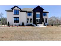 Beautiful, modern two-story home with painted brick, black trim, and a well-manicured lawn at 3066 Reserve Ct Sw, Conyers, GA 30094
