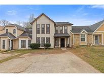 Charming exterior of a two-story home with a classic design and well-maintained landscaping at 4715 Old Highgate Entry, Stone Mountain, GA 30083