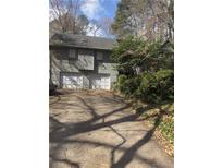 View of home's front exterior featuring a two-car garage and traditional architecture at 1040 Rolling Green Dr, Acworth, GA 30102