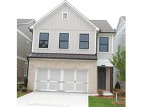 Charming two-story home with brick and siding, featuring a two-car garage and well-manicured lawn at 1071 Crest Mill Dr, Marietta, GA 30008