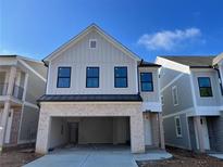 New two-story home featuring a brick facade, a two-car garage, and black-trimmed windows at 1071 Crest Mill Dr, Marietta, GA 30008