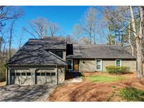 Charming home featuring a two-car garage, well-maintained lawn, and neutral-colored exterior at 2249 Chimney Springs Dr, Marietta, GA 30062