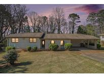 Charming single-story home featuring a well-maintained front yard, a carport, and an inviting entrance at 803 Denise Sw Ct, Stone Mountain, GA 30087