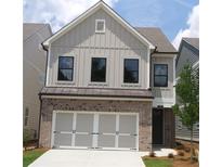 Charming two-story home with a brick and siding exterior and an attached two-car garage at 1062 Crest Mill Dr, Marietta, GA 30008